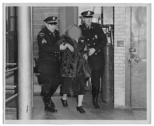 Sergeant Arthur Moskos and Chief James Goonan with an unknown woman, Plymouth Police Station, circa 1950